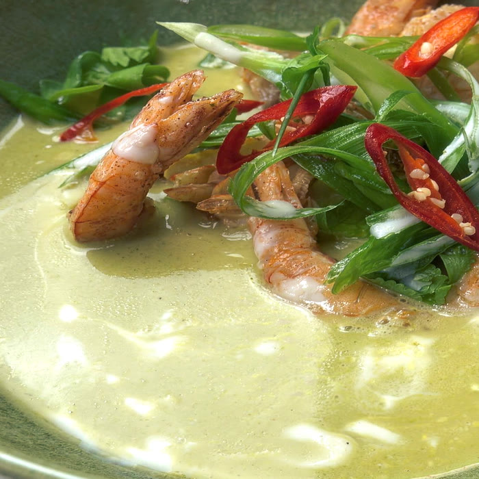Red chilli, scallion and cilantro over coconut curry