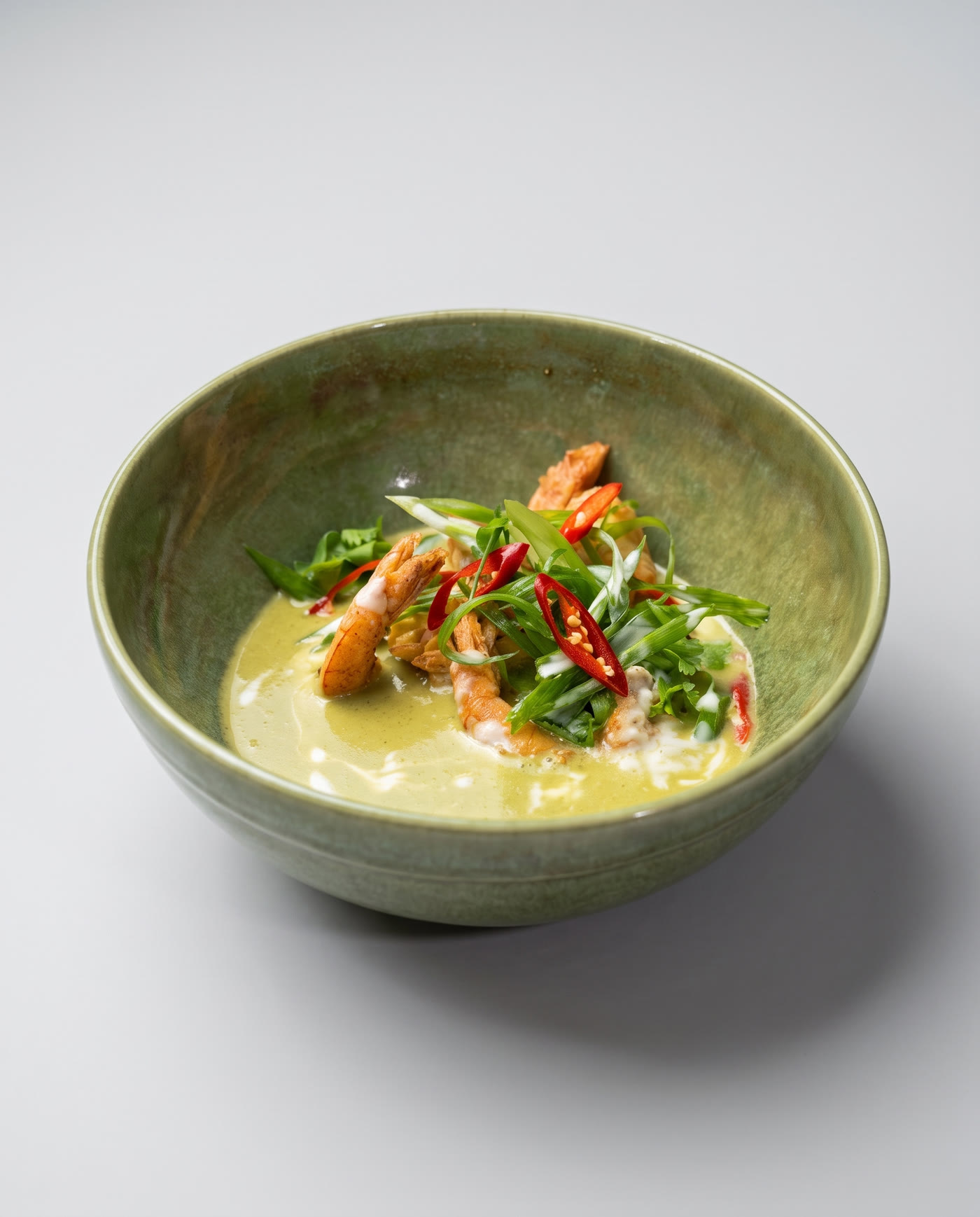 Crisp shrimp over a coconut curry, finished with scallion, chilli and cilantro
